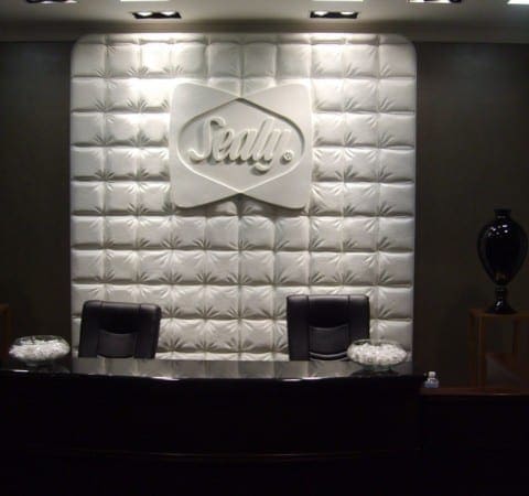 Image of commercial lobby reception desk and wall-mounted backdrop