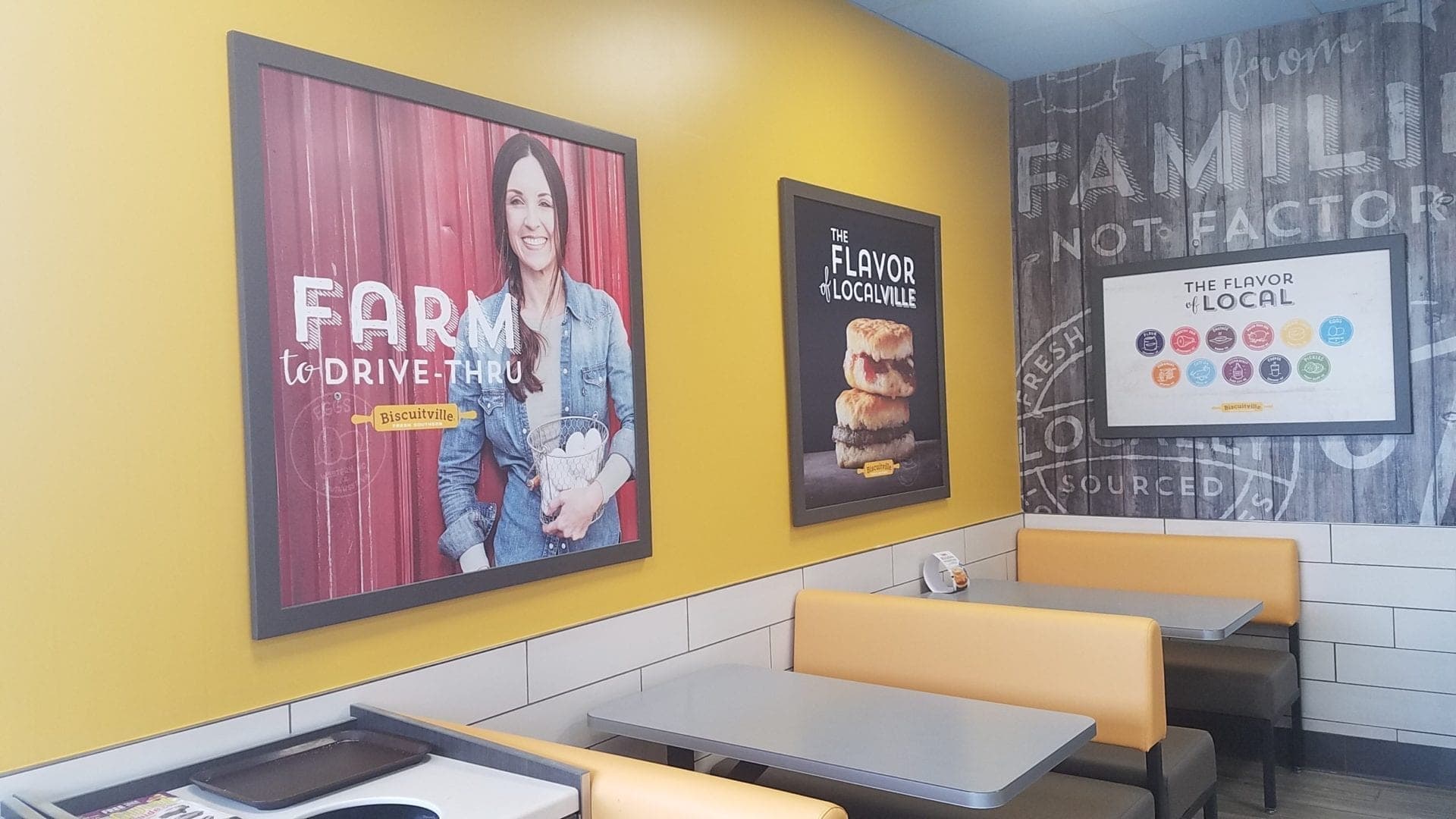 Biscuitville fast food corporate branded interior with large framed printed graphics, vinyl wall wrap, and corporate furnishing