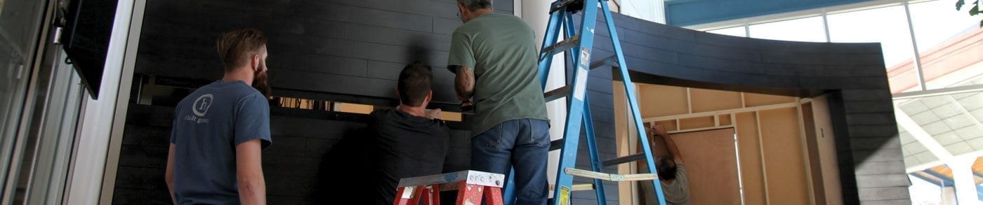 Installation of custom dark woodwork wall panels