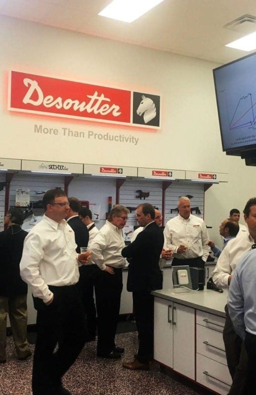 Business people in Desoutter tools show room with custom fabricated cabinets and wall displays with custom vinyl graphics