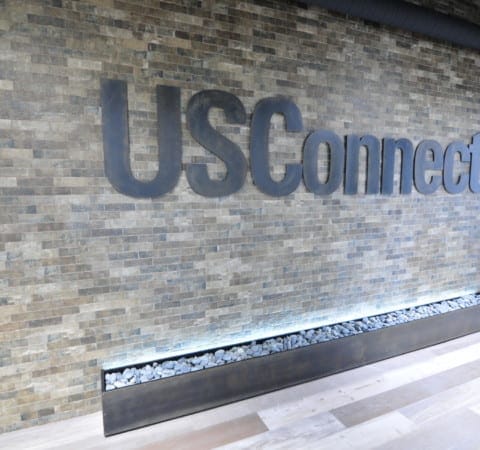 USConnect metal CNC cut wall logo with backlit custom fabricated rock planter