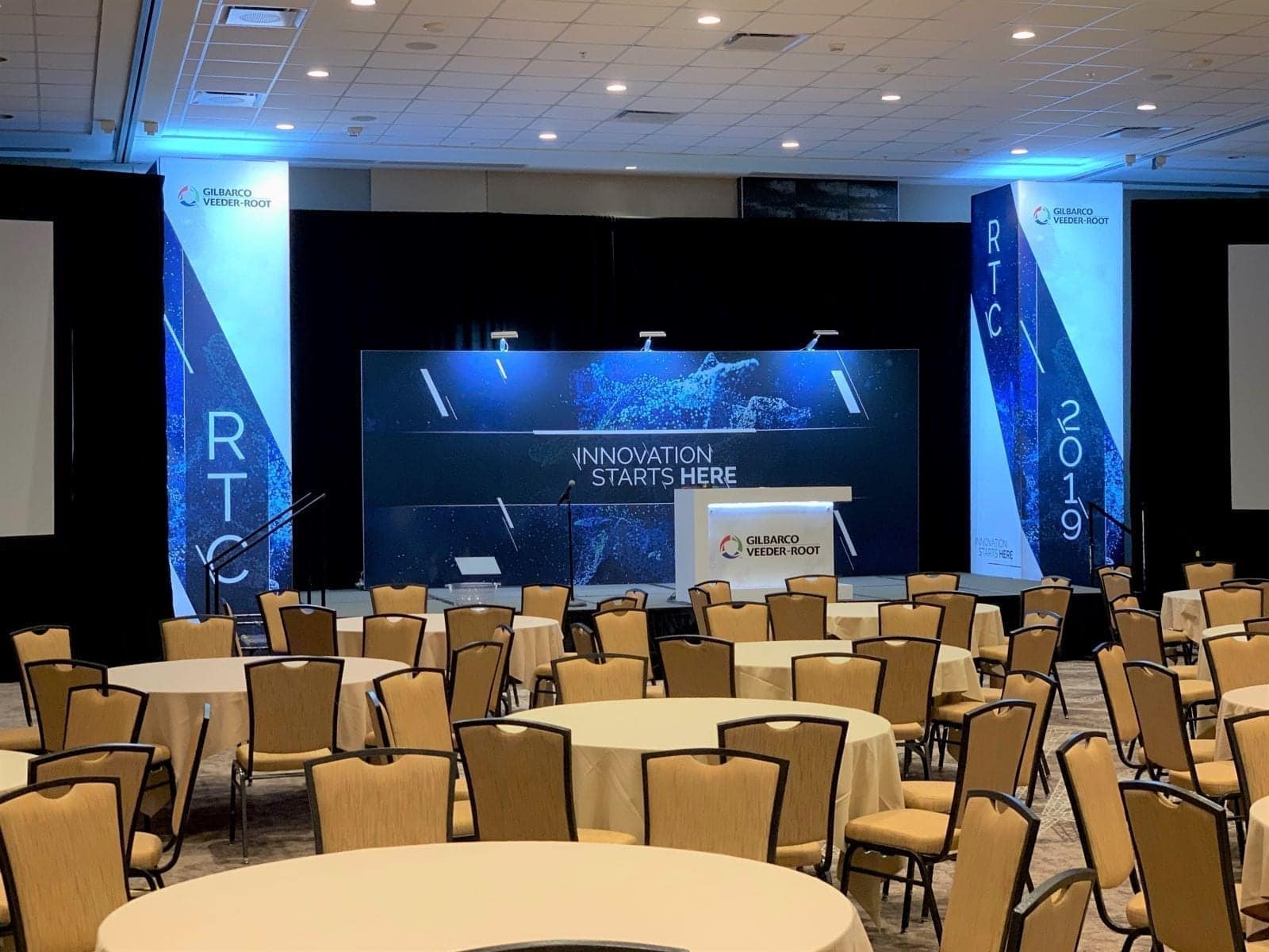 Gilbarco RTC main event stage wich custom large format stage backdrop with lighting and illuminated towers