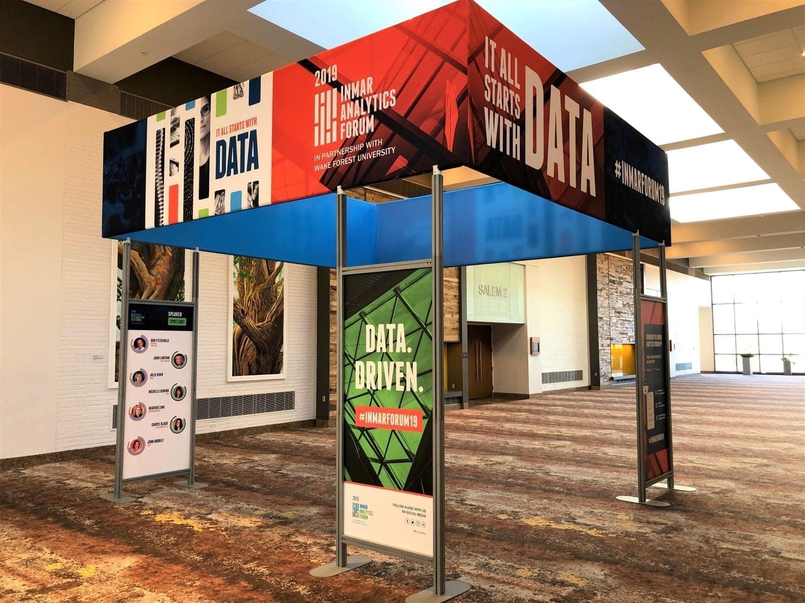 Event exhibit with color printed fabric branding signage supported by custom color graphic displays at Inmar Analytics Forum