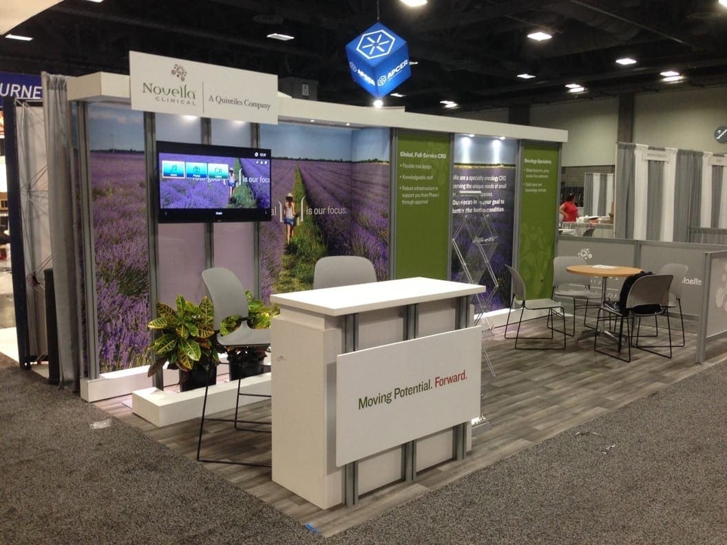 Small trade show exhibit with reception desk and seating for visitors