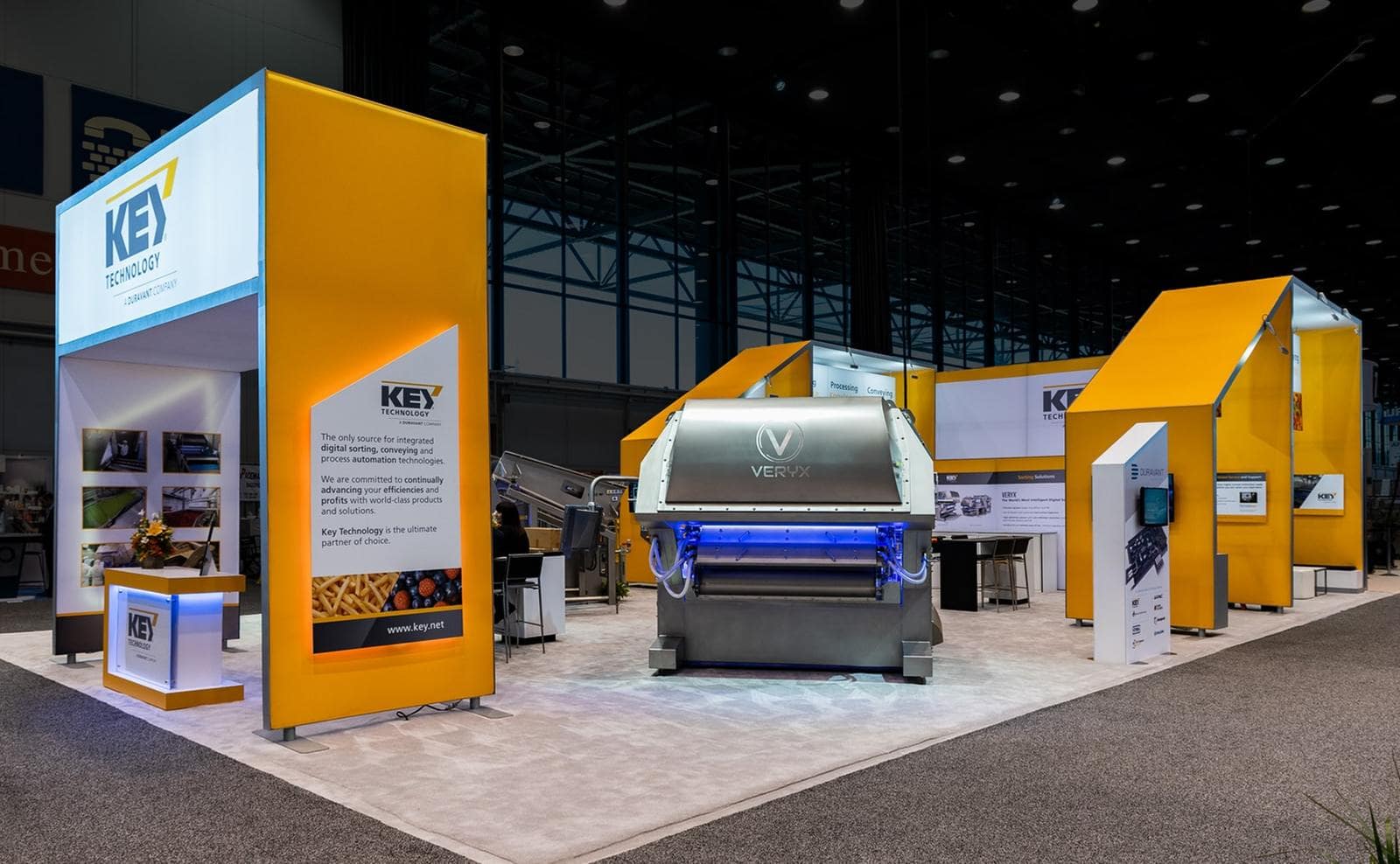 Trade show exhibit with reception desk, lightweight structures, and comfortable seating for visitors