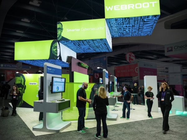 Trade show exhibit with unique stair ceiling-suspended structure with branded logo and information stations