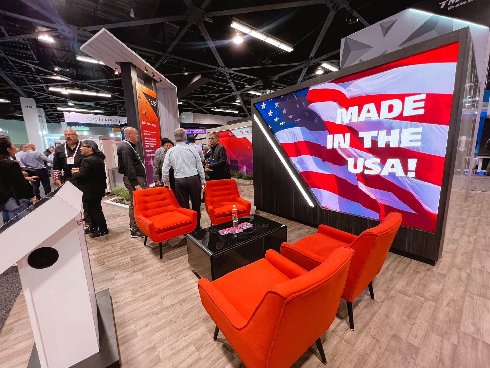 TMEIC 30x50 island trade show exhibit at RE+ 2024 - LED screen and seating