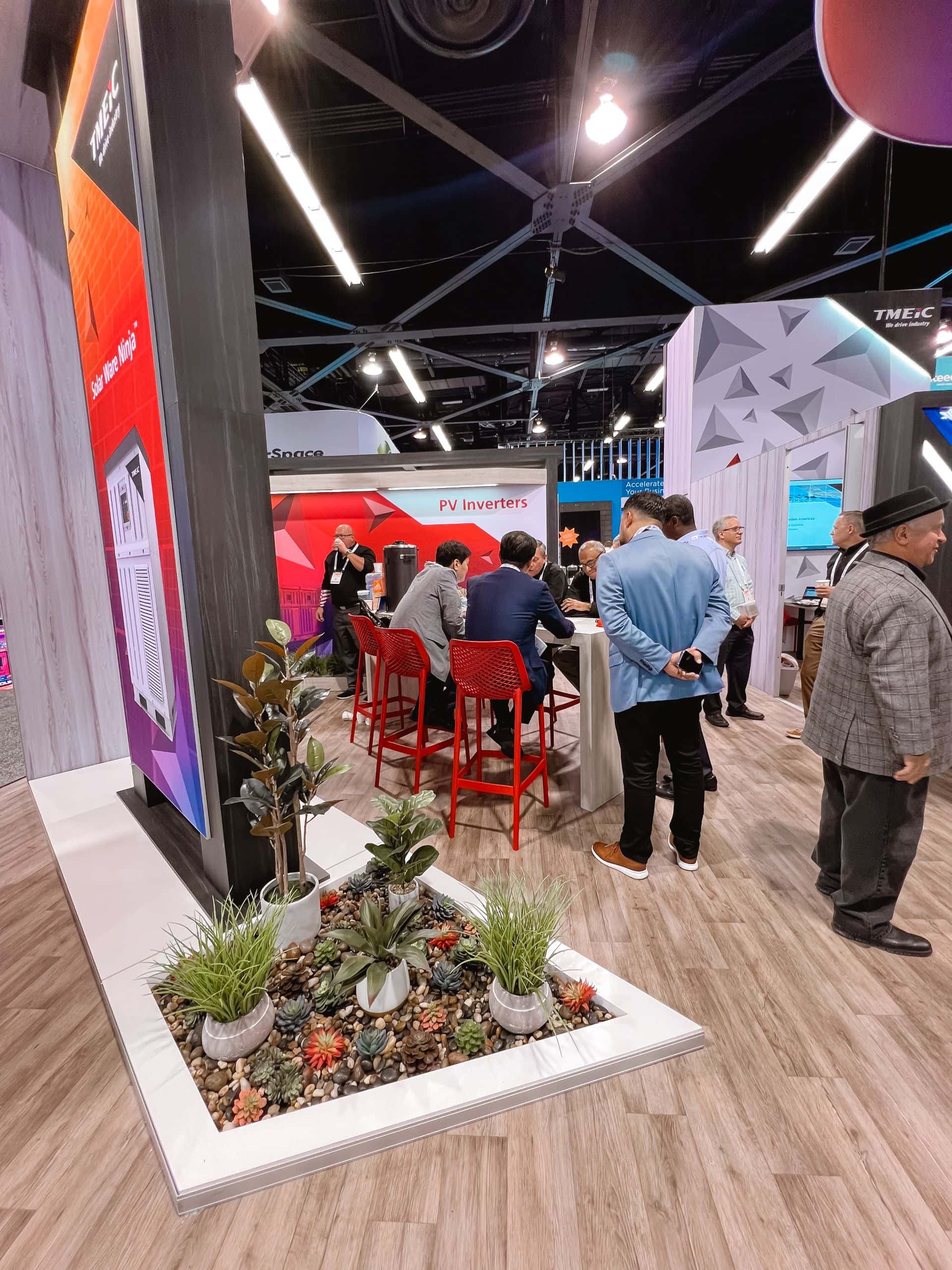 TMEIC 30x50 island trade show exhibit at RE+ 2024 - tower and plants