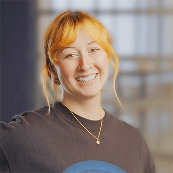 Engaging young woman smiling at startup event, tech conference, or corporate team building.