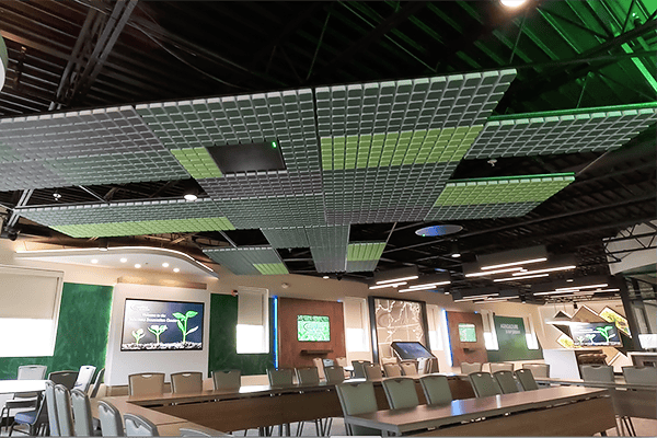 Wide shot of completed Coastal AgroBusiness Innovation Center with digital screens, custom furnishings, branding, and ceiling design by Holt Experiential.