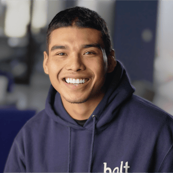 Bright young man smiling at Holt Experiential event, engaging in innovative activities.