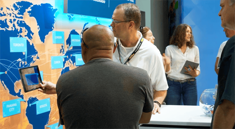 Vibrant business conference at Holt Experiential with interactive global map display.
