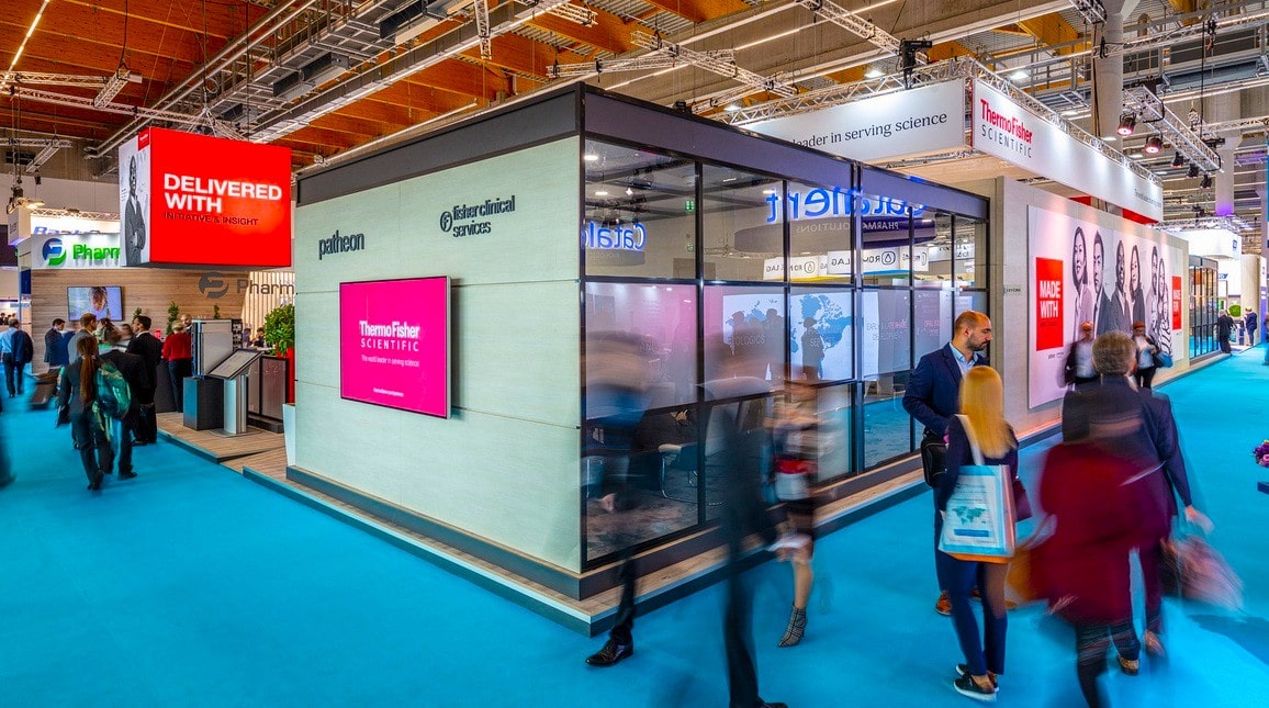 Innovative trade show booth by Holt Experiential with interactive digital displays and vibrant branding.