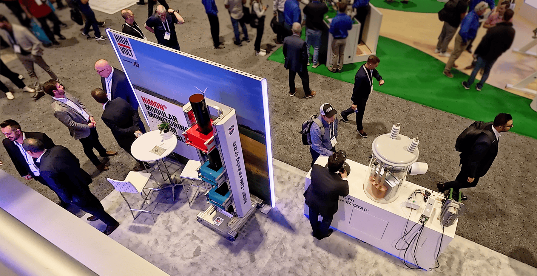 View from the second-floor meeting area overlooking Reinhausen's interactive product displays and customer engagement spaces at IEEE 2026.
