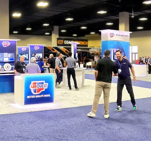 CarQuest Summit 2026 exhibit designed and fabricated by Holt Experiential, featuring branded product displays, interactive digital screens, and illuminated CarQuest signage.